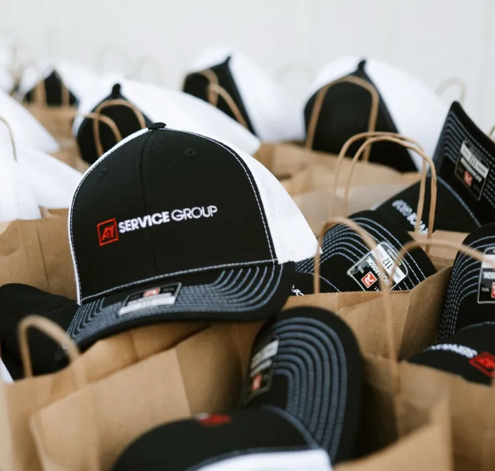 Rows of gift bags with company hats